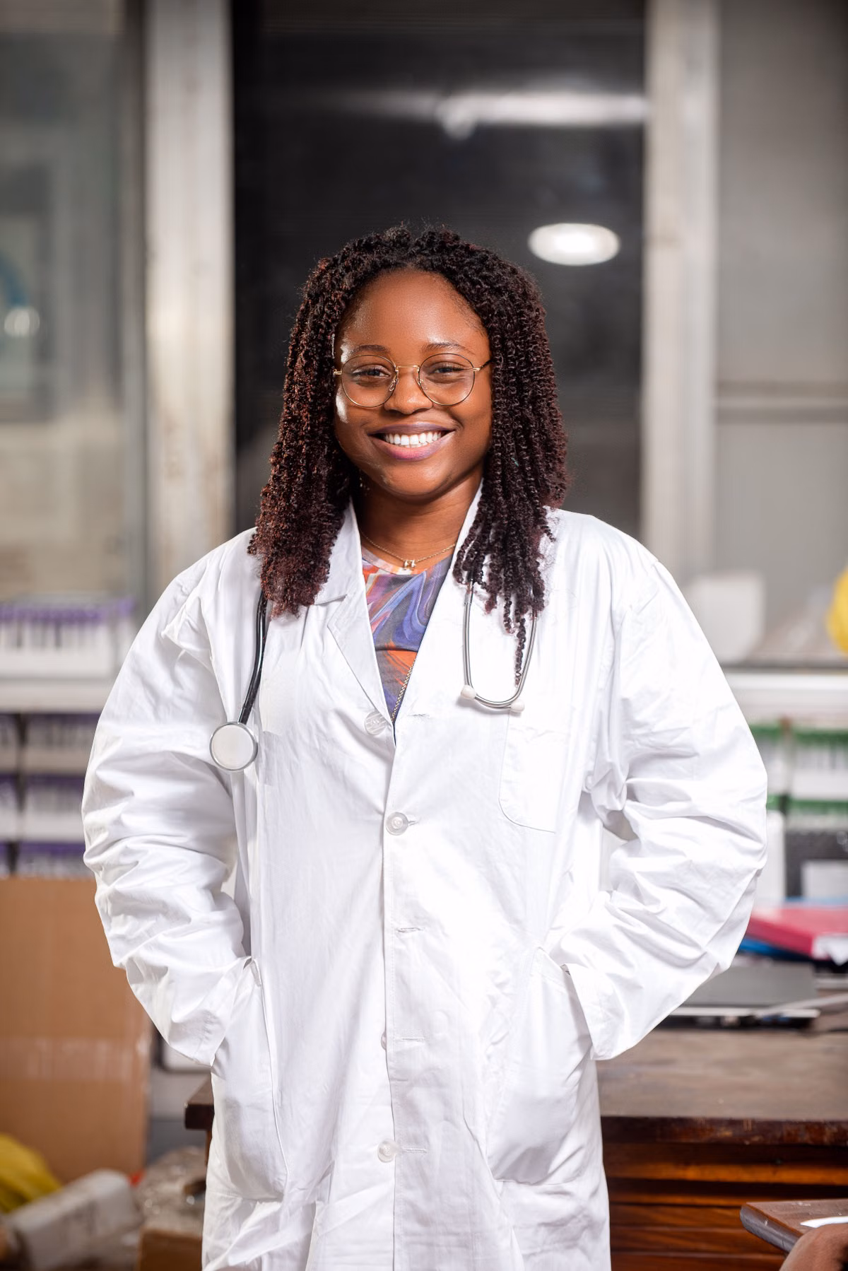 Smiling physician in a lab coat standing in a clinical setting